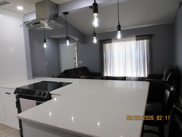 443 SW Homeland Rd, Port Saint Lucie, FL 34953 - kitchen with vaulted ceiling, electric stove, visible vents, white cabinets, and extractor fan