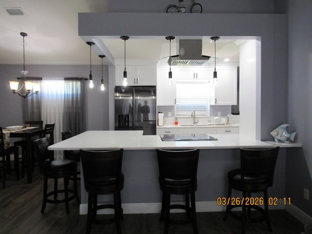 443 SW Homeland Rd, Port Saint Lucie, FL 34953 - kitchen featuring dark wood-style flooring, white cabinets, light countertops, black electric stovetop, and stainless steel refrigerator with ice dispenser