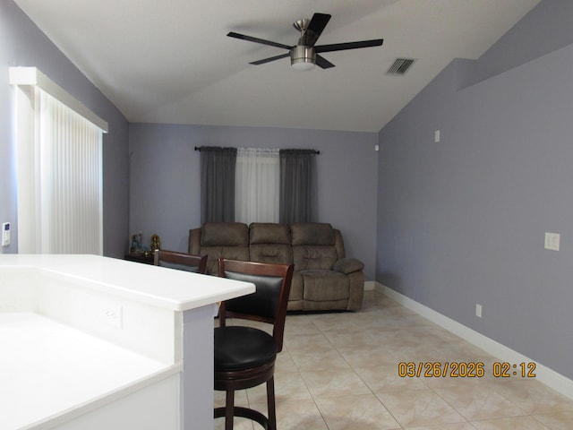 443 SW Homeland Rd, Port Saint Lucie, FL 34953 - living area featuring light tile patterned floors, lofted ceiling, visible vents, and a ceiling fan