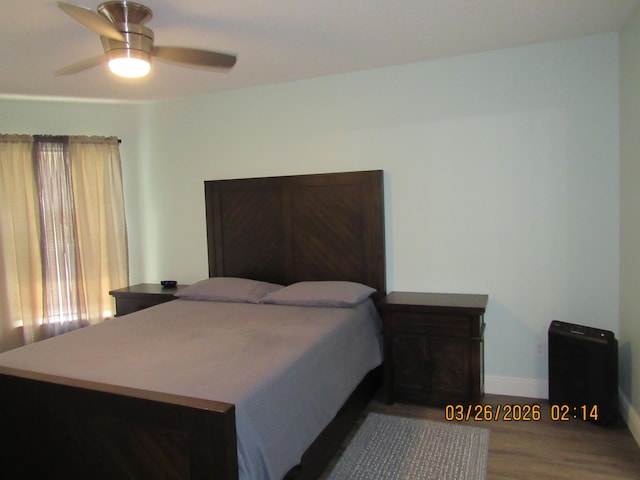 443 SW Homeland Rd, Port Saint Lucie, FL 34953 - bedroom with baseboards, wood finished floors, and a ceiling fan