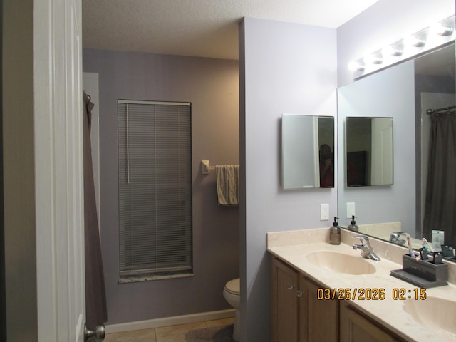 443 SW Homeland Rd, Port Saint Lucie, FL 34953 - full bath with tile patterned floors, toilet, a sink, baseboards, and double vanity