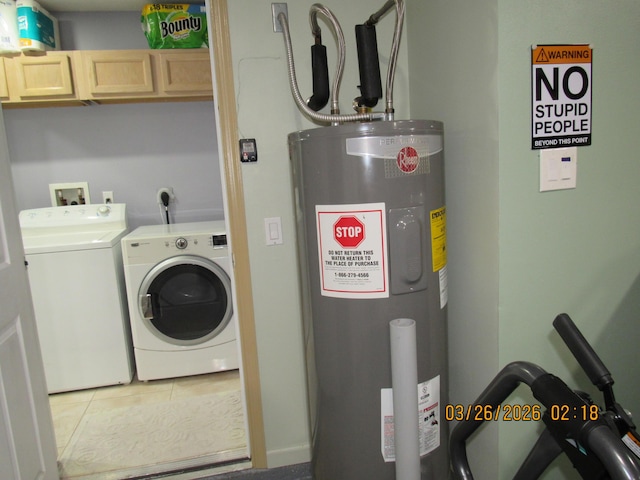 443 SW Homeland Rd, Port Saint Lucie, FL 34953 - clothes washing area with tile patterned floors, electric water heater, washing machine and clothes dryer, and cabinet space