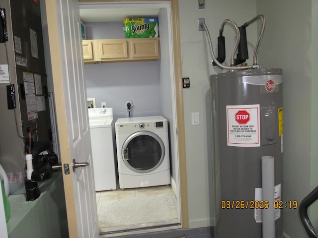 443 SW Homeland Rd, Port Saint Lucie, FL 34953 - laundry area featuring tile patterned flooring, electric water heater, separate washer and dryer, heating unit, and cabinet space