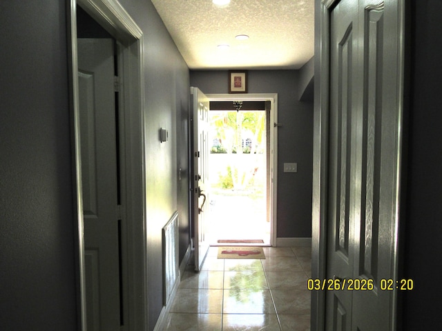 443 SW Homeland Rd, Port Saint Lucie, FL 34953 - tiled entryway with baseboards, visible vents, and a textured ceiling