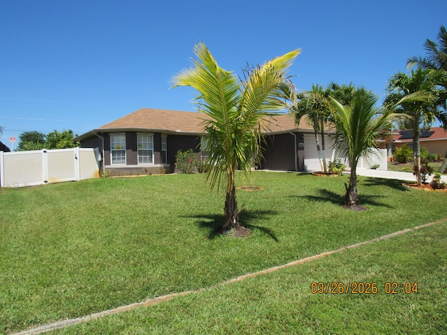 443 SW Homeland Rd, Port Saint Lucie, FL 34953 - ranch-style home with a front yard, a gate, fence, and stucco siding