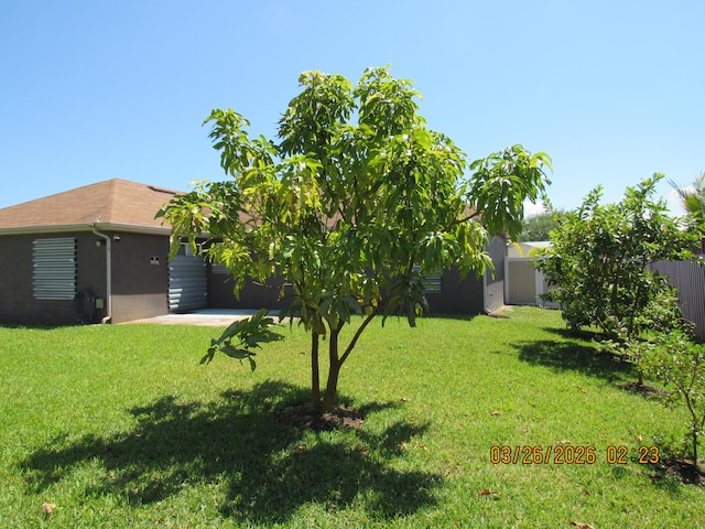 443 SW Homeland Rd, Port Saint Lucie, FL 34953 - back of house featuring a lawn, fence, and stucco siding
