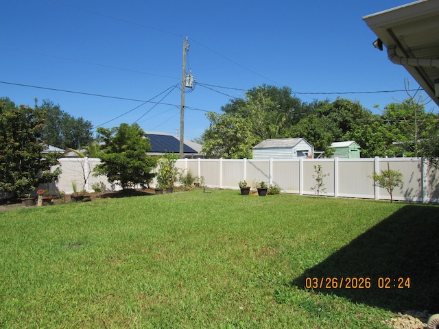 443 SW Homeland Rd, Port Saint Lucie, FL 34953 - back of property with a patio area and a lawn