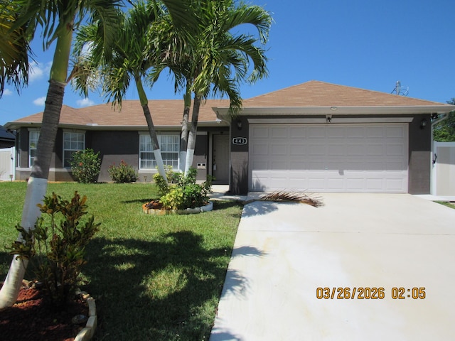 443 SW Homeland Rd, Port Saint Lucie, FL 34953 - ranch-style home featuring an attached garage, concrete driveway, and a front yard