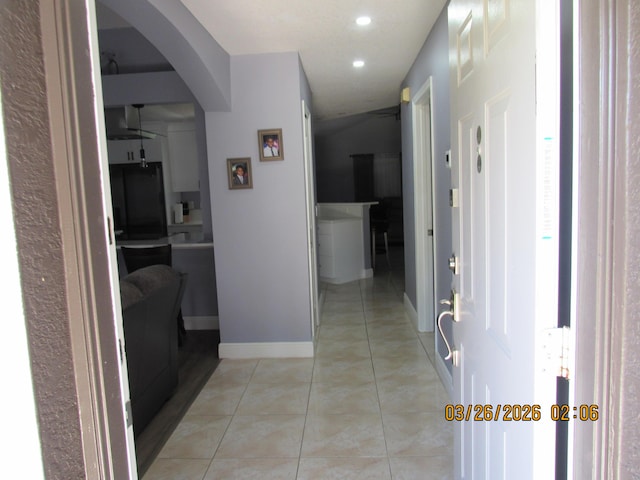 443 SW Homeland Rd, Port Saint Lucie, FL 34953 - corridor with light tile patterned floors, arched walkways, baseboards, and recessed lighting