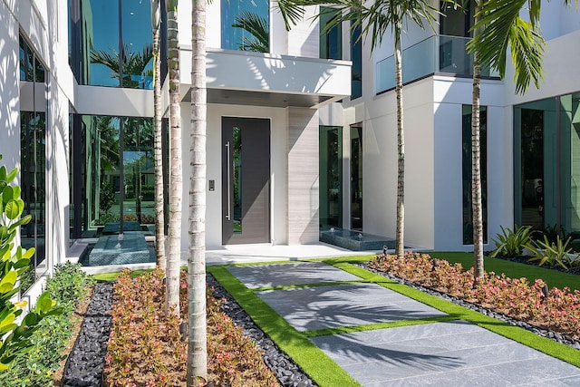 372 E Alexander Palm Rd, Boca Raton, FL 33432 - doorway to property with stucco siding