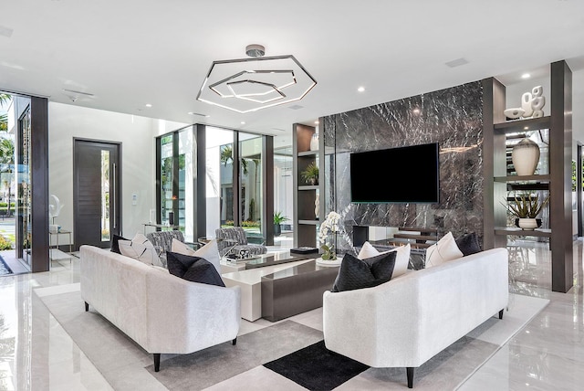 372 E Alexander Palm Rd, Boca Raton, FL 33432 - living room with an accent wall, floor to ceiling windows, stone wall, recessed lighting, and marble finish floor