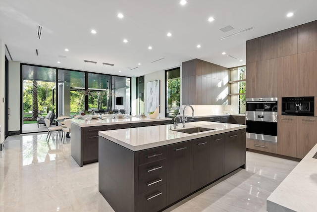 372 E Alexander Palm Rd, Boca Raton, FL 33432 - kitchen with marble finish floor, modern cabinets, a sink, and a spacious island