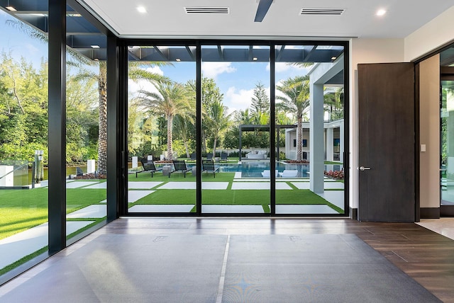 372 E Alexander Palm Rd, Boca Raton, FL 33432 - doorway to outside with visible vents, a wall of windows, and wood finished floors