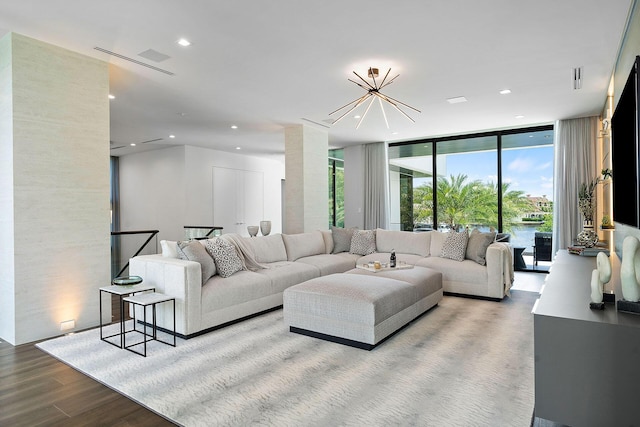372 E Alexander Palm Rd, Boca Raton, FL 33432 - living area featuring recessed lighting, a wall of windows, an inviting chandelier, and wood finished floors