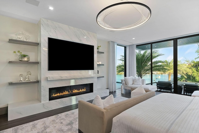372 E Alexander Palm Rd, Boca Raton, FL 33432 - bedroom featuring recessed lighting, wood finished floors, access to outside, a premium fireplace, and expansive windows