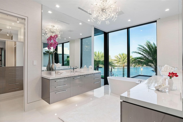 372 E Alexander Palm Rd, Boca Raton, FL 33432 - bathroom with vanity, visible vents, a wall of windows, a chandelier, and a freestanding bath