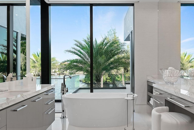 372 E Alexander Palm Rd, Boca Raton, FL 33432 - full bath featuring a water view, vanity, and a soaking tub