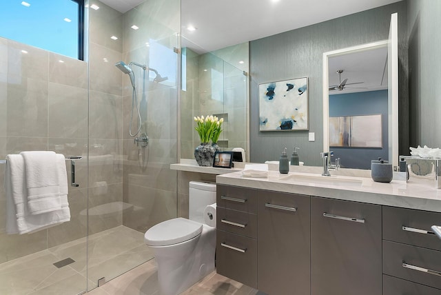 372 E Alexander Palm Rd, Boca Raton, FL 33432 - full bathroom with ceiling fan, a shower stall, vanity, tile patterned flooring, and toilet