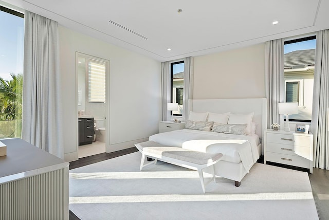 372 E Alexander Palm Rd, Boca Raton, FL 33432 - bedroom featuring visible vents, connected bathroom, and wood finished floors