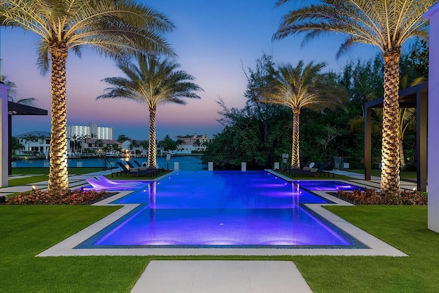 372 E Alexander Palm Rd, Boca Raton, FL 33432 - view of pool with a yard, a pool with connected hot tub, and a water view