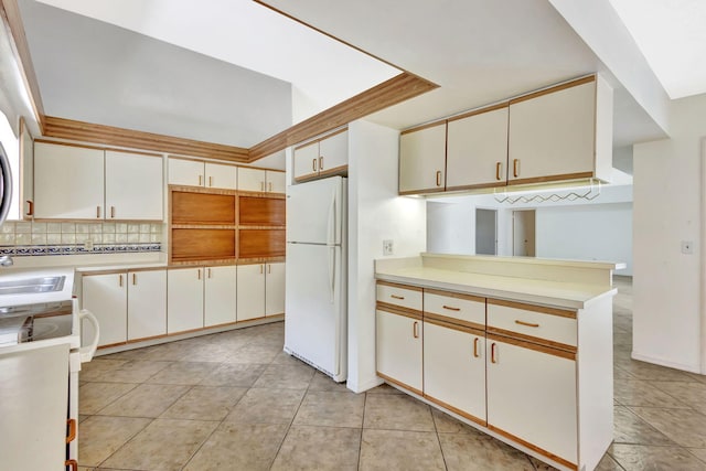 2101 SE Harlow St, Port Saint Lucie, FL 34952 - kitchen with range, decorative backsplash, light countertops, and freestanding refrigerator