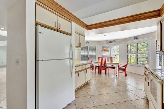2101 SE Harlow St, Port Saint Lucie, FL 34952 - kitchen featuring white appliances, light countertops, white cabinets, pendant lighting, and light tile patterned flooring