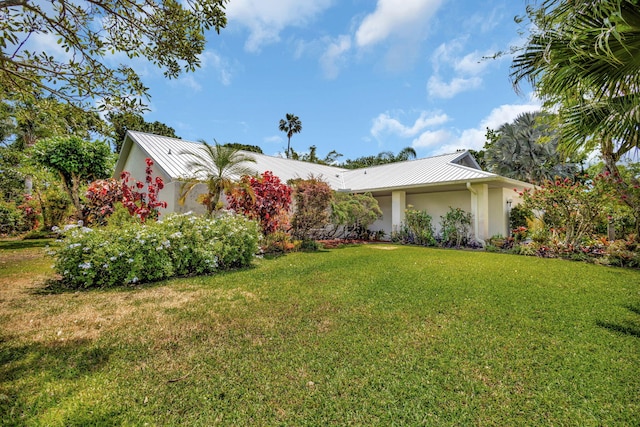2101 SE Harlow St, Port Saint Lucie, FL 34952 - exterior space with metal roof, a front yard, stucco siding, and a standing seam roof