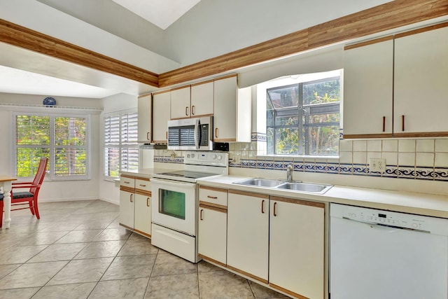 2101 SE Harlow St, Port Saint Lucie, FL 34952 - kitchen featuring backsplash, white appliances, light countertops, and a sink