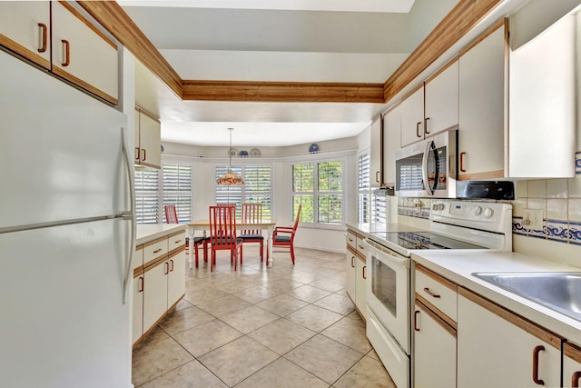 2101 SE Harlow St, Port Saint Lucie, FL 34952 - kitchen featuring white appliances, decorative backsplash, light tile patterned floors, light countertops, and pendant lighting