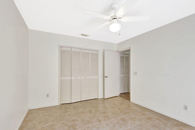 2101 SE Harlow St, Port Saint Lucie, FL 34952 - unfurnished bedroom with a closet, ceiling fan, baseboards, visible vents, and light tile patterned flooring