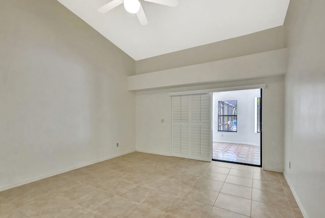 2101 SE Harlow St, Port Saint Lucie, FL 34952 - spare room featuring light tile patterned floors, a ceiling fan, high vaulted ceiling, and baseboards