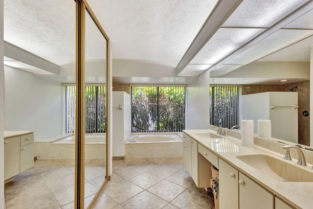 2101 SE Harlow St, Port Saint Lucie, FL 34952 - bathroom with a garden tub, double vanity, a sink, and a textured ceiling