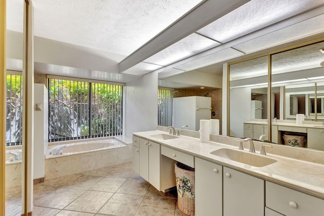 2101 SE Harlow St, Port Saint Lucie, FL 34952 - full bathroom with a garden tub, double vanity, a sink, and a textured ceiling