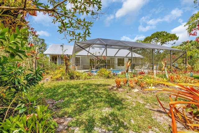 2101 SE Harlow St, Port Saint Lucie, FL 34952 - view of yard featuring an outdoor pool and glass enclosure