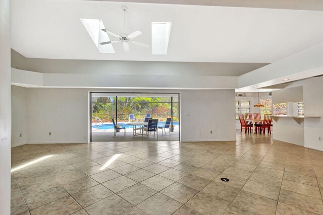 2101 SE Harlow St, Port Saint Lucie, FL 34952 - tiled spare room with a skylight, high vaulted ceiling, and baseboards