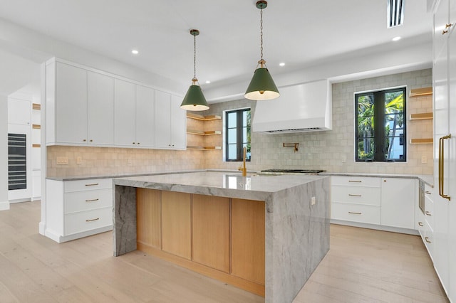 3408 Washington Rd, West Palm Beach, FL 33405 - kitchen with wall chimney exhaust hood, open shelves, decorative backsplash, recessed lighting, and light stone countertops