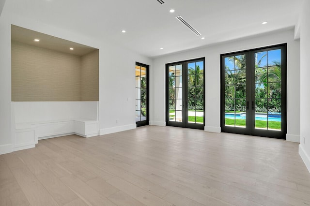 3408 Washington Rd, West Palm Beach, FL 33405 - empty room with french doors, light wood-style floors, and recessed lighting