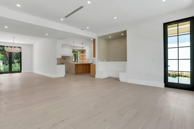 3408 Washington Rd, West Palm Beach, FL 33405 - unfurnished living room featuring recessed lighting, a chandelier, light wood finished floors, and baseboards