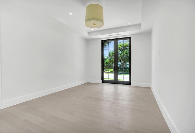 3408 Washington Rd, West Palm Beach, FL 33405 - unfurnished room featuring wood finished floors, french doors, a raised ceiling, baseboards, and recessed lighting