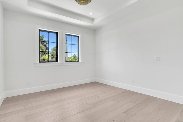 3408 Washington Rd, West Palm Beach, FL 33405 - unfurnished room featuring light wood-type flooring, baseboards, a raised ceiling, and recessed lighting