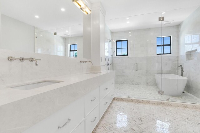 3408 Washington Rd, West Palm Beach, FL 33405 - bathroom featuring a stall shower, a soaking tub, double vanity, recessed lighting, and tile walls