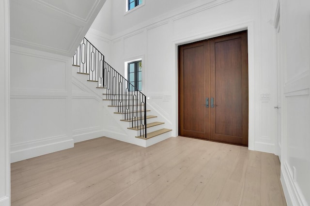 3408 Washington Rd, West Palm Beach, FL 33405 - foyer entrance with a decorative wall, stairway, plenty of natural light, and light wood-type flooring