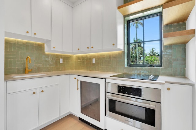 3408 Washington Rd, West Palm Beach, FL 33405 - kitchen featuring oven, a sink, wine cooler, and light countertops