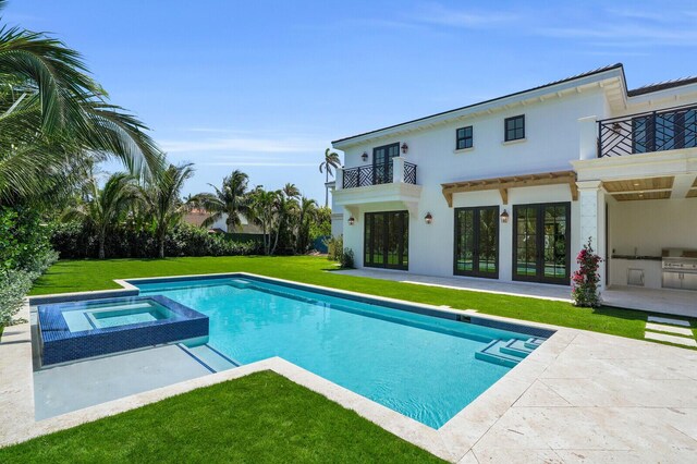 3408 Washington Rd, West Palm Beach, FL 33405 - view of swimming pool featuring a patio, a lawn, french doors, and a pool with connected hot tub
