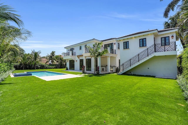 3408 Washington Rd, West Palm Beach, FL 33405 - rear view of property featuring a balcony, an outdoor pool, a lawn, stairs, and stucco siding