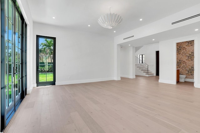 3408 Washington Rd, West Palm Beach, FL 33405 - unfurnished living room featuring light wood-type flooring, stairs, baseboards, and recessed lighting