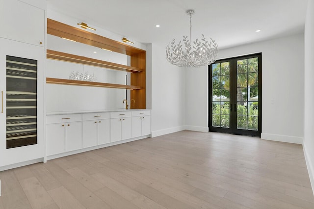 3408 Washington Rd, West Palm Beach, FL 33405 - unfurnished dining area with french doors, light wood finished floors, a chandelier, baseboards, and recessed lighting
