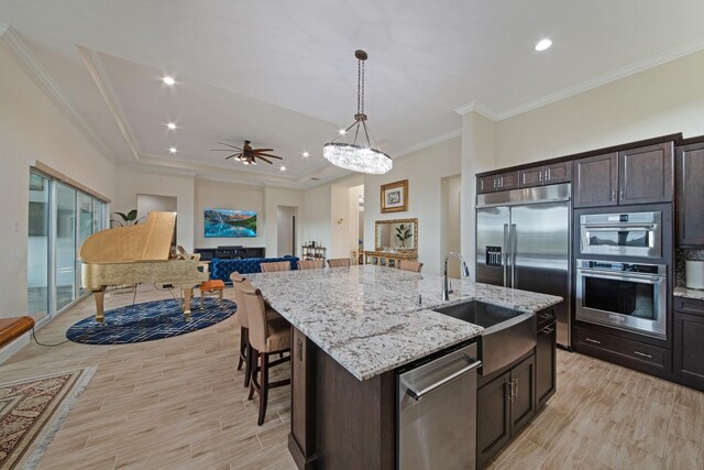 4673 Estates Cir, Westlake, FL 33470 - kitchen featuring stainless steel appliances, a sink, a kitchen island with sink, pendant lighting, and light wood finished floors