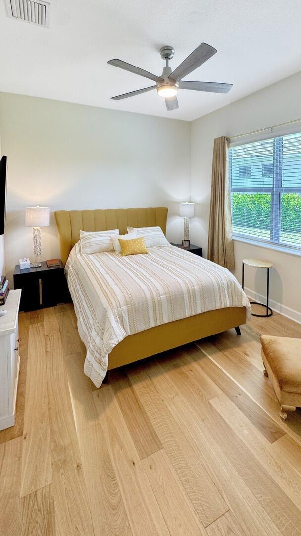 4673 Estates Cir, Westlake, FL 33470 - bedroom with light wood finished floors and ceiling fan