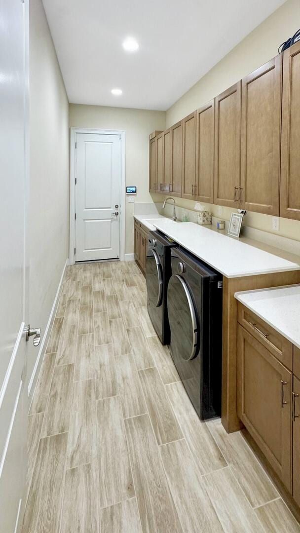4673 Estates Cir, Westlake, FL 33470 - clothes washing area with light wood-style floors, cabinet space, separate washer and dryer, baseboards, and recessed lighting